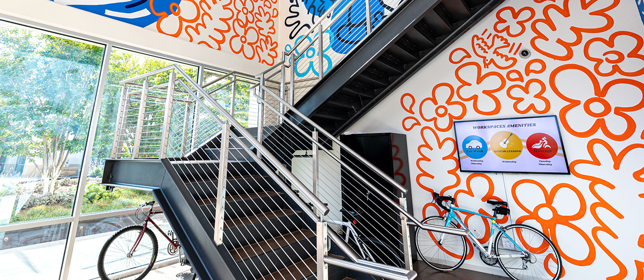 stairwell with bikes and colorful murals
