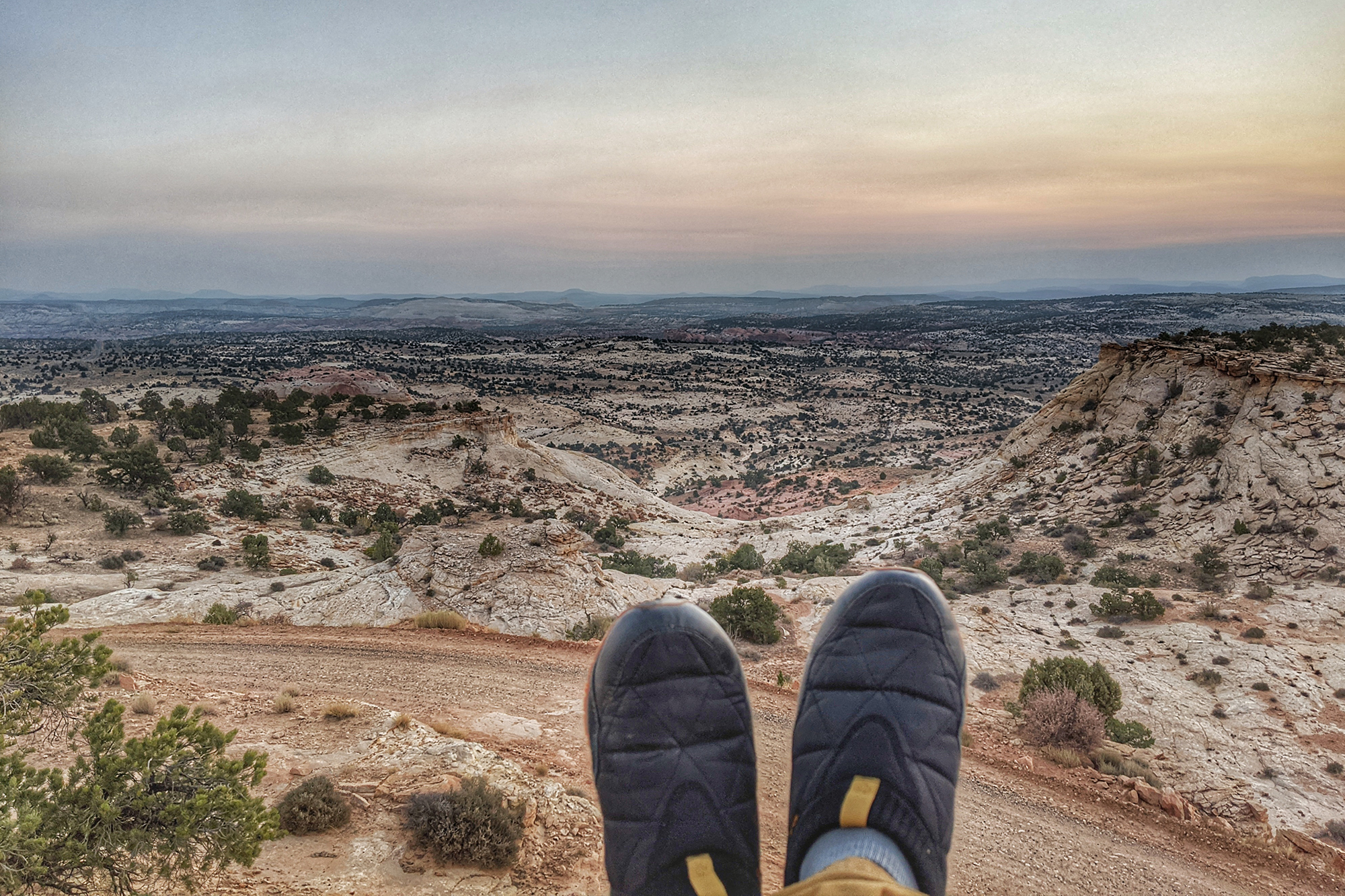 shoes in front of vast desert landscape