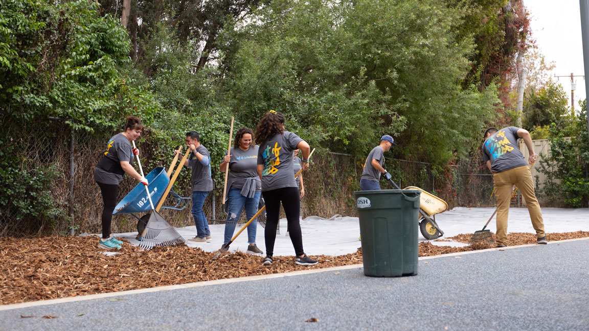 Group of volunteers landscaping at a school playground